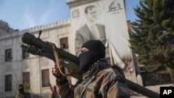 A Syrian opposition fighter holds a rocket launcher in front of the provincial government office, where an image of Syrian President Bashar Assad is riddled with bullets on the facade, in the aftermath of the opposition's takeover of Hama, Dec. 6, 2024. 