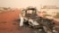 A man takes a close look at a burned-out truck in Timbuktu, Mali, January 31, 2013. 