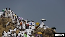 Muslim pilgrims visit Mount Mercy on the plains of Arafat during the annual haj pilgrimage, outside the holy city of Mecca, Sept. 23, 2015. 