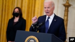 FILE - President Joe Biden speaks in the East Room of the White House as Vice President Kamala Harris listens, in Washington, May 10, 2021.