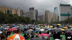 People holding umbrellas gather at Victoria Park to take part in an anti-extradition bill protest in Hong Kong, Aug. 11, 2019. 