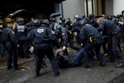 A man is detained while Black Lives Matter members and others confront NYPD during a march against the far-right movement and Trump administration in the Manhattan borough of New York City, Nov. 1, 2020.
