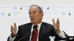 FILE - Former New York City Mayor Michael Bloomberg, right, gestures as he speaks during a panel discussion on "Climate Change and Financial Markets"at the COP21, United Nations Climate Change Conference, in Le Bourget north of Paris, Dec. 4, 2015. 
