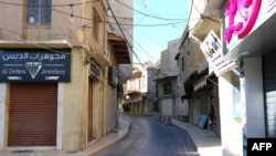 FILE - This picture shows closed shops on an empty street in the eastern Lebanese city of Baalbek on Oct. 19, 2024.
