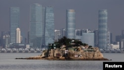 FILE - Shiyu, or Lion Islet, which is part of Kinmen county, one of Taiwan's offshore islands, is seen in front of China's Xiamen, on Lieyu island, Kinmen county, Taiwan, Aug. 20, 2018. 