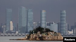 FILE - Shiyu, which is part of Kinmen County, one of Taiwan's offshore islands, is seen in front of China's Xiamen, on Lieyu island, Kinmen County, Taiwan, Aug. 20, 2018. Chinese drones have been flying over a handful of Taiwan-held islands within eyesight of the mainland.