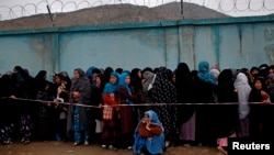 Afghan women stand in line to vote at a polling station in Kabul April 5, 2014. 