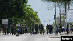 Mutinying soldiers stand next to their camp as they protest over a pay dispute in the centre of the commercial capital Abidjan, Ivory Coast, May 12, 2017.