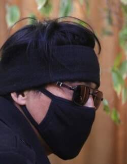 FILE - In this Feb. 26, 2019, photo, Abdullah, a former Afghan fighter in Syria with the Fatimiyoun Brigade, wears a mask to hide his identity during an interview with The Associated Press in Kabul, Afghanistan.
