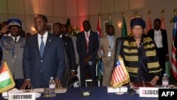 Ivory Coast's president Alassane Ouattara (L) and Liberia's president Ellen Johnson Sirleaf look on during the 49th summit of the Economic Community of West African States (ECOWAS) in Dakar, Senegal, June 4, 2016. 