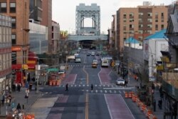 There is little traffic on 125th Street, April 16, 2020, in the Harlem neighborhood of New York during the coronavirus pandemic.