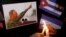 FILE - People place candles beside a picture of Fidel Castro, as part of a tribute, following the announcement of the death of the Cuban revolutionary leader, in Tegucigalpa, Honduras, Nov. 26, 2016.