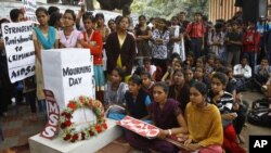 Indians gather next to a makeshift memorial to mourn the death of a 23-year-old gang rape victim, in Bangalore, India , Saturday, Dec. 29, 2012. 