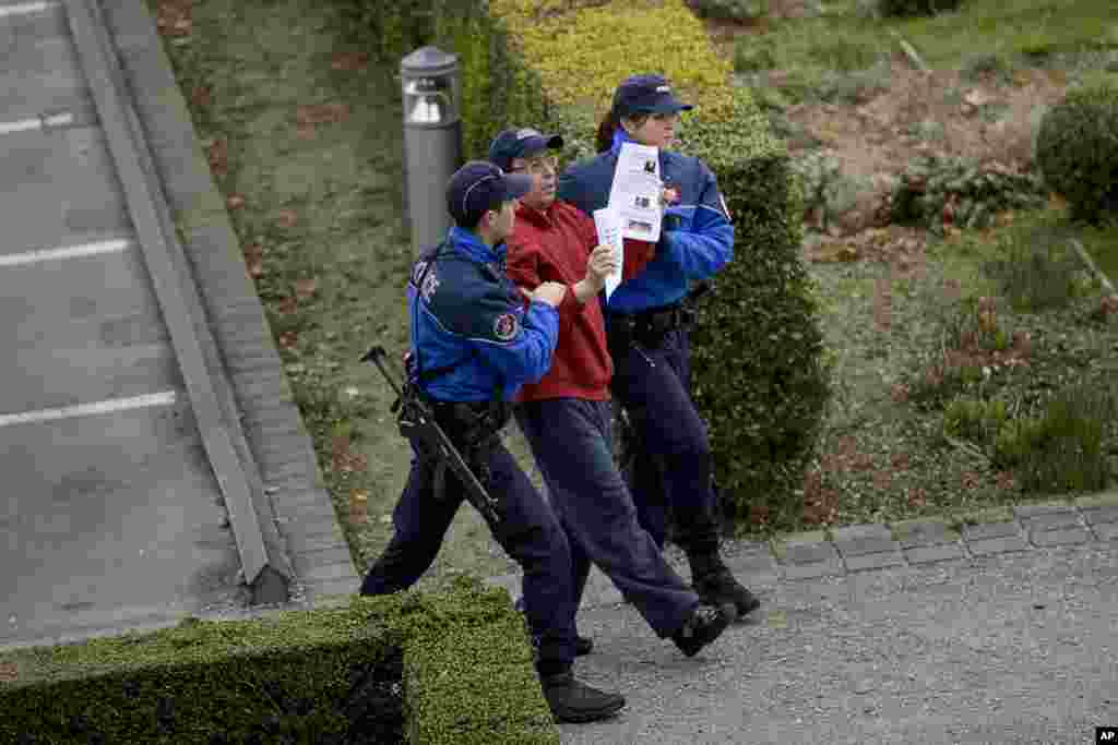 Police remove a protester near the Beau Rivage Palace Hotel where an extended round of talks on Iran's nuclear program is taking place, in Lausanne, April 2, 2015.