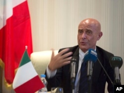 FILE - Italian Interior Minister Marco Minniti speaks during a meeting with Libyan Interior Minister Al-Arif Saleh Al-Khoja and the mayors of Libyan municipalities, to discuss the problem they face with migrants attempting to cross the Mediterranean Sea, July 13