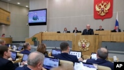In this handout photo provided by The State Duma, The Federal Assembly of the Russian Federation, Russian Tax Service chief Mikhail Mishustin speaks during a session at the State Duma, Jan. 16. 2020.
