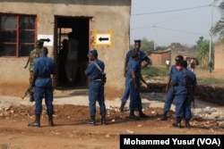 Security forces stand guard at the polling station in Cibitoke neighborhood, Bujumbura. The station experienced low voter turnout after the sounds of gunfire were heard around the center.