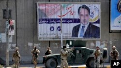 Afghan security forces work at the site of a suicide attack near the U.S. Embassy in Kabul, Afghanistan, Sept. 17, 2019.