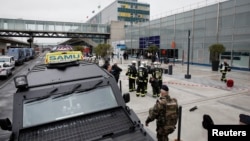 Military and emergency services outside Orly airport southern terminal after a shooting incident near Paris, France, March 18, 2017. 