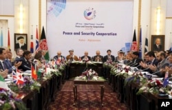 FILE - President Ashraf Ghani, center, is seen during the so-called Kabul Process conference at the Presidential Palace in Kabul, Afghanistan, June 6, 2017.