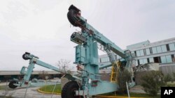 A crane used at the port to move cargo from ships lays on top of a restaurant after the passing of Hurricane Maria in the La Guancha area of Ponce, Puerto Rico, Sept. 21, 2017.