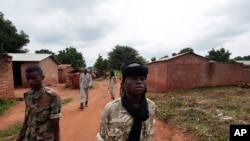 FILE - Seleka rebels walk through the town of Bria, Central African Republic, July 15, 2013. Recent fighting between rival militia groups in the Central African Republic has killed 16 people, U.N. peacekeepers said Wednesday, Nov. 23, 2016.