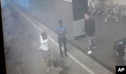 FILE - This image provided by Star TV of closed circuit television footage from Feb. 13, 2017, shows a woman, left, at Kuala Lumpur International Airport in Sepang, Malaysia, who police say was arrested Wednesday in connection with the death of Kim Jong Nam.