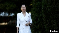 FILE - Huawei Technologies Chief Financial Officer Meng Wanzhou leaves her home to appear for a hearing in Vancouver, British Columbia, Canada, Sept. 30, 2019.