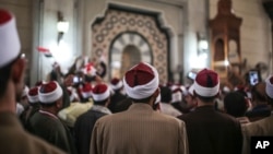 FILE - Muslim clerics are seen gathered at a mosque in central Cairo, Egypt, Feb. 3, 2015. Muslim clerics and scholars not in line with Islamic State postulates have been the latest target of IS propaganda videos.