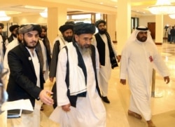 FILE - In this Sept. 12, 2020 photo, a Taliban delegation arrive to attend the opening session of the peace talks between the Afghan government and the Taliban in Doha, Qatar.