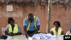 An electoral worker sorts ballots during the counting of votes for Guinea-Bissau's presidential runoff on Dec. 29, 2019, in Bissau.