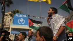 Palestinians march through Manara Square in central Ramallah passing a symbolic wooden chair erected to represent the UN seat they aspire, September 22, 2011
