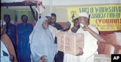 A divorcee trained as a tailor receives a sewing machine as a gift from the Directorate of Employment in Kano. (photo courtesy of VOWAN)
