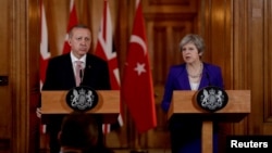 Turkey's President Recep Tayyip Erdogan and British Prime Minister Theresa May take part in a news conference after their meeting at 10 Downing Street in London, Britain, May 15, 2018.