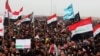 FILE - Sunni protesters chant slogans against the Iraq's Shiite-led government as they wave national flags during a 2013 demonstration in Fallujah.