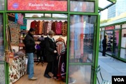 Small business owner Shujaat Kemma, left, is cautiously optimistic of his candidate’s chances. “I do have a good feeling of who is going to be the president, and that is actually helping me,” Kemma said, Nov. 7, 2016. (R. Taylor/VOA)