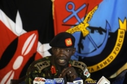 FILE - Kenya Army Colonel Cyrus Oguna speaks during a press conference in Nairobi's military headquarters, Nov. 26, 2011.