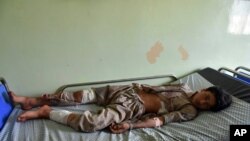 A wounded boy receives treatment at a hospital after a car bomb blast on an intelligence compound in Aybak, Afghanistan, July 13, 2020. Taliban insurgents launched an attack on the compound, officials said.