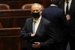 FILE - In this Sunday, June 13, 2021, file photo, Israeli politician Benny Gantz stands during a Knesset session in Jerusalem.