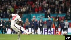 England's Bukayo Saka has his shot saved in the penalty shoot-out during the Euro 2020 soccer championship final match between England and Italy at Wembley Stadium in London, July 11, 2021.