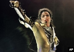 FILE - Michael Jackson performs during a concert in Vienna