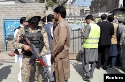 A soldier stands guard near the site of a suicide attack at a sessions court compound in Shabqadar, northwestern Pakistan, March 7, 2016.