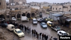 FILE - Former members of Syria's Bashar al-Assad's security forces wait in line to register for the identification and reconciliation process, after the ousting of al-Assad, in Aleppo, Syria, Dec. 23, 2024.