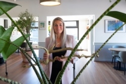 FILE - Femke Zimmerman, manager of Brasserie Berlage, a cafe and restaurant nestled in the manicured gardens of The Hague's historic art deco Kunstmuseum, poses for a portrait as she prepares the restaurant for reopening, April 24, 2020.