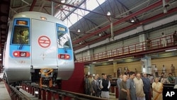 Delhi Metro officials tour metro train facility in New Delhi, Sept. 17, 2002.