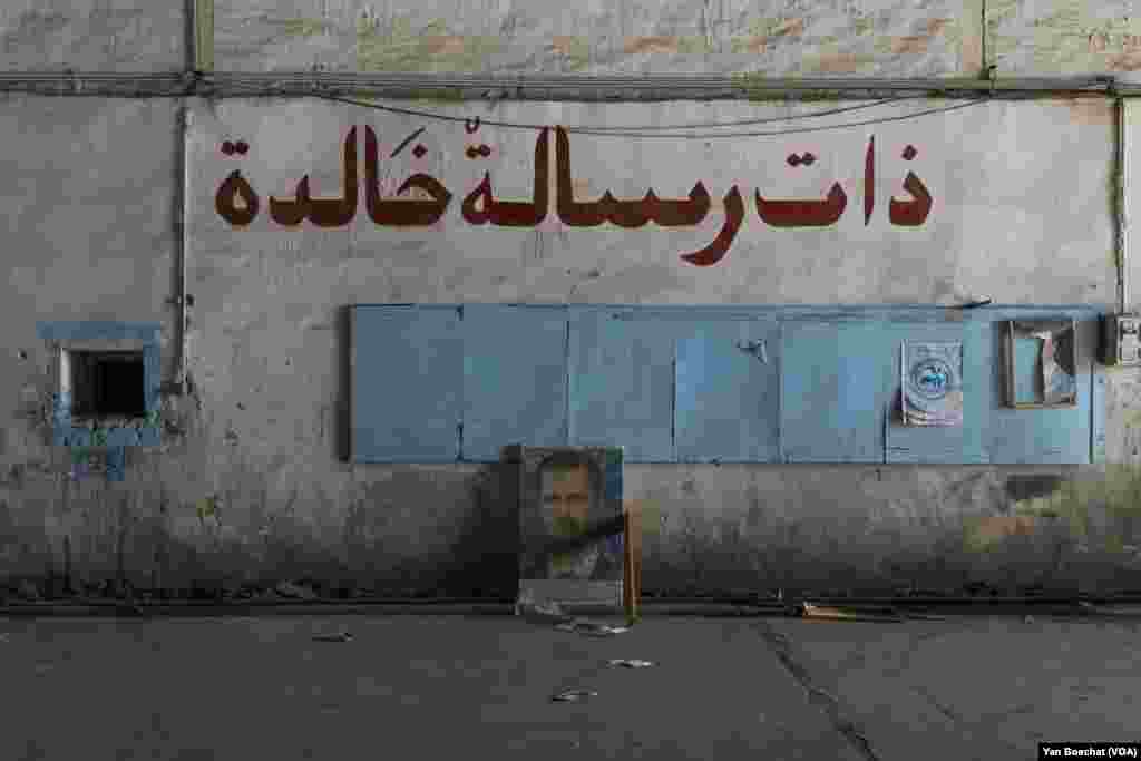 One of the few posters with the Bashar al-Assad&rsquo;s face still intact inside the Mazzeh air base, in Damascus, on Dec. 19, 2024. (Yan Boechat/VOA)