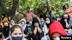 Afghan nationals react at a gathering to urge the international community to help Afghan refugees, in New Delhi, India, August 18, 2021. 