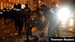 Law enforcement officers detain a man during a rally in support of jailed Russian opposition leader Alexei Navalny in Moscow, Jan. 23, 2021.