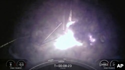 This image created from a SpaceX video, shows the moment when the SpaceX Falcon 9 rocket's first-stage fell over in flames after landing on an ocean platform offshore, Aug. 28, 2024, in the Atlantic Ocean. 
