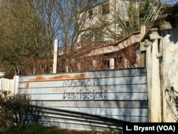 A sign outside Paris calling for France's pro-EU president, Emmanuel Macron, to step down. The National Rally is profiting from his headaches.